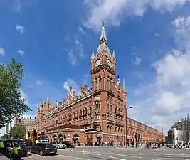 red stone building with tall clock tower in corner