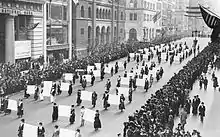 Women's suffragists parade in New York City in 1917, carrying placards with signatures of more than a million women.
