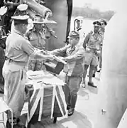 The official surrender ceremony of the Japanese to the Australian forces on board HMAS Kapunda at Kuching, Kingdom of Sarawak, on 11 September 1945