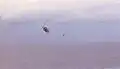 RVNAF pilot jumps from his Huey after dropping evacuees on USS Midway