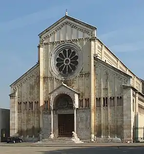 Church of San Zeno, Verona, Italy, The facade is neatly divided vertically and horizontally. The central wheel window and small porch with columns resting on crouching lions is typical of Italy.
