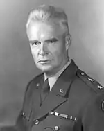 A Caucasian man in his late 50s with gray hair in a military uniform