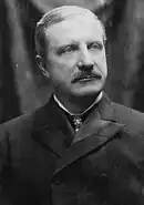 Mustached man in an overcoat